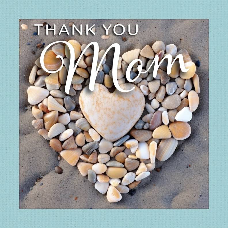 Thank You Mom” gift book showing a heart made of beach pebbles on sand with a teal cloth-wrapped border.