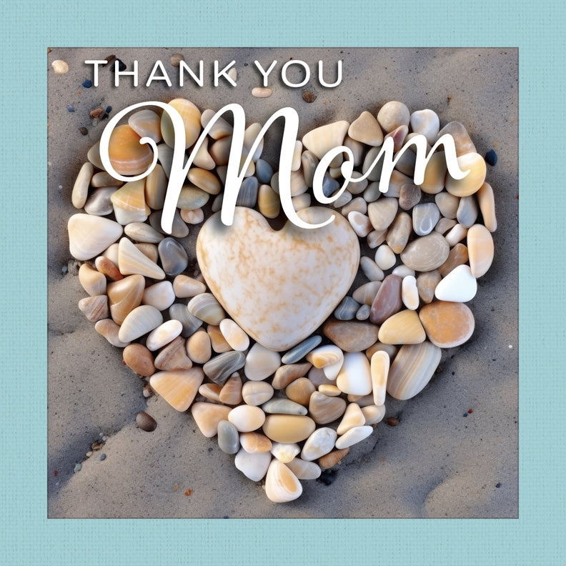 Thank You Mom” gift book showing a heart made of beach pebbles on sand with a teal cloth-wrapped border.